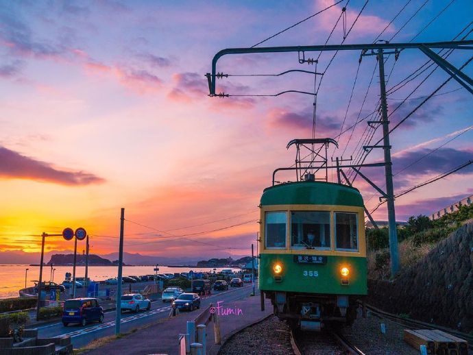 夕阳西下，日本海边乡镇的有轨电车配上这金黄落日画面太美了