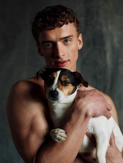 抱着一个狗狗的小平头欧美肌肉男写真图片