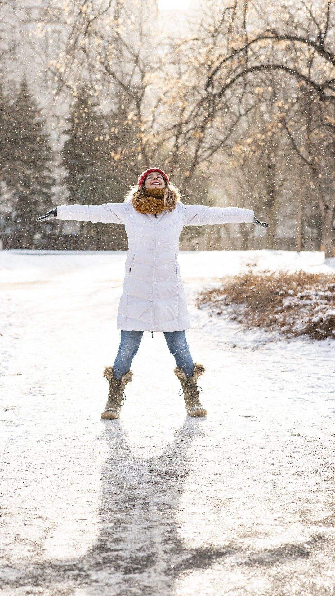 下雪天 户外 穿白色羽绒服 张开双臂的欧美少女手机壁纸图片