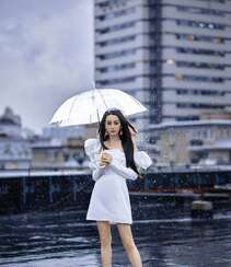 迪丽热巴纯白连衣裙穿着，手拿雨伞，雨中漫步优雅迷人青春写真图片组图1