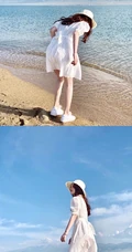 女生鞠婧祎一袭白裙装扮海边沙滩游玩写真照片