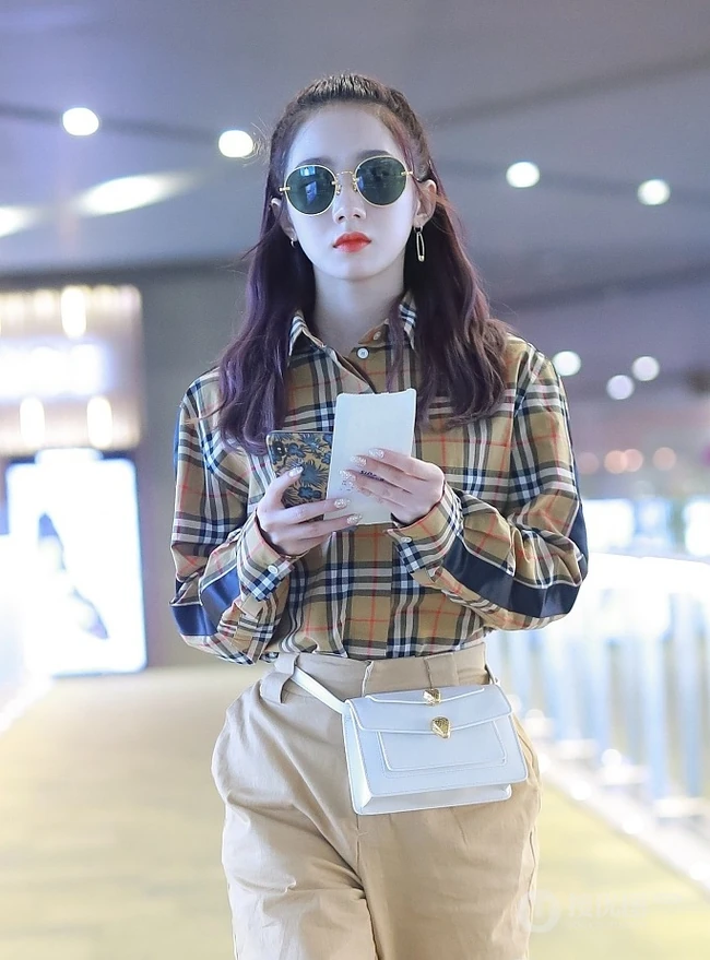 孟美岐穿着时尚戴墨镜现身机场，格纹衬衫搭长裤高挑清新