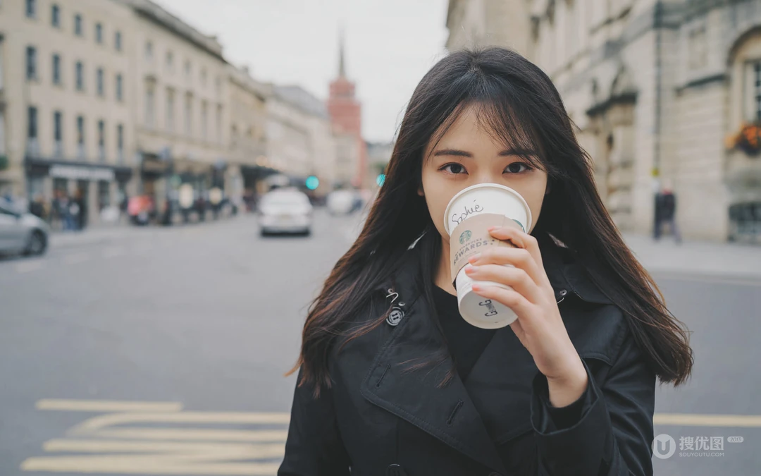 冬季街头，繁华都市的咖啡厅里喝着咖啡的欧美女生高清壁纸