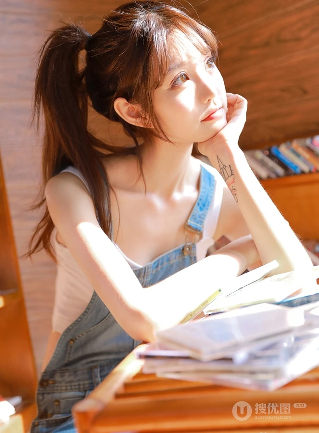 甜美动人马尾辫肩带牛仔裤少女室内晒太阳温暖写真图片