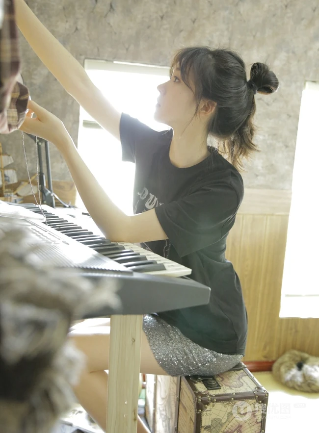 动人小脸丸子头文艺少女黑T银裙室内沙发写真图片