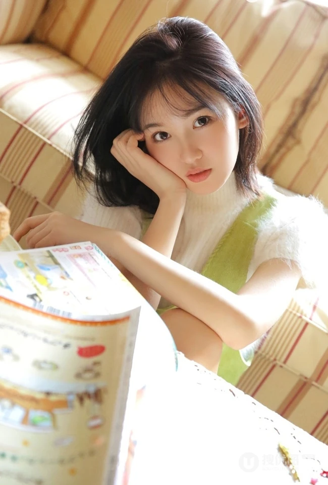 笑容动人肩带绿衣短裤线条感少女怡然室内写真图片