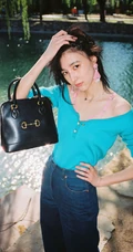 王悦伊公园湖边复古意境美照，V领上衣搭牛仔裤色彩复古照旧