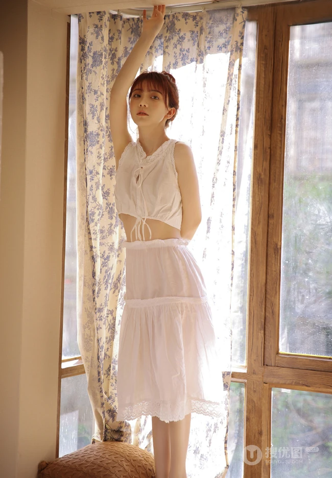 看起来不开心的丸子头漂亮女生白衣长裙清爽夏日写真图片