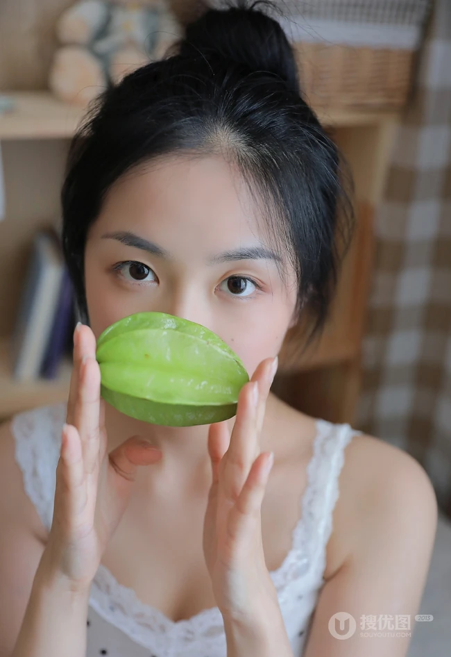 手拿杨桃的清纯丸子头少女清新室内写真