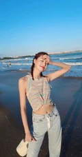 李斯羽针织小背心搭配牛仔长裤，大秀纤细线条海边写真美照