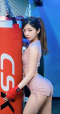 拳击台上的气质单马尾发型女生，身着紧身运动衣短裤，尽显挺翘线条