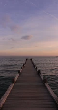唯美的海上木栈道夕阳手机壁纸
