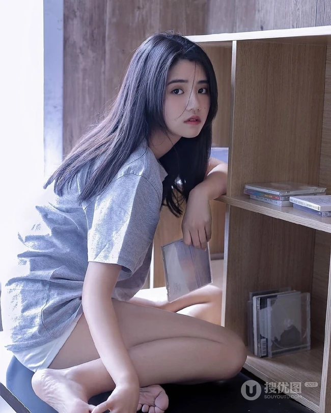 抱膝而坐，恬静温柔，长发T恤衫短裤文静型女孩居家写真图片