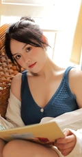 气质清纯低领装短裤少女居家看杂志，吃水果悠闲曝光写真图片