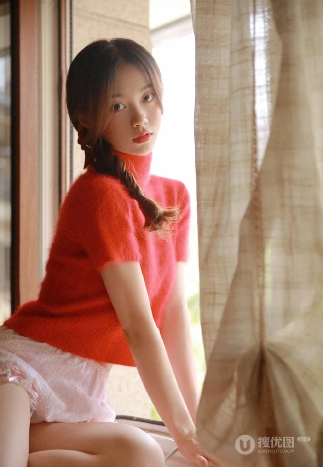 穿红色针织衫毛衣短裤的大眼睛单麻花辫美丽女孩艺术室内摄影图片