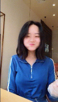 边吃东西，边摇头晃脑的可爱笑容女生gif动态图片