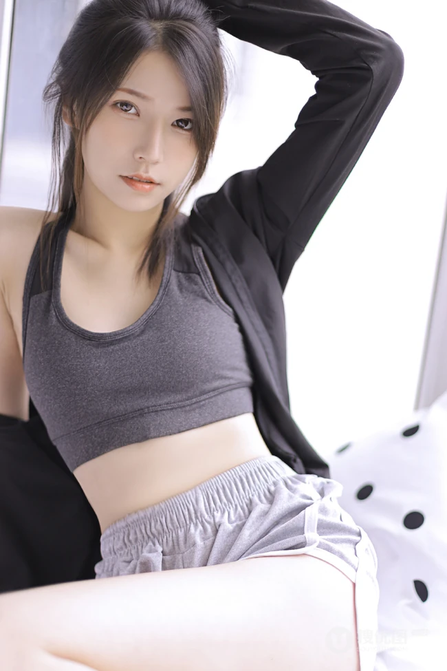 穿着运动肩带小背心短裤听音乐的马尾辫清新少女显蛮腰线条感室内图片