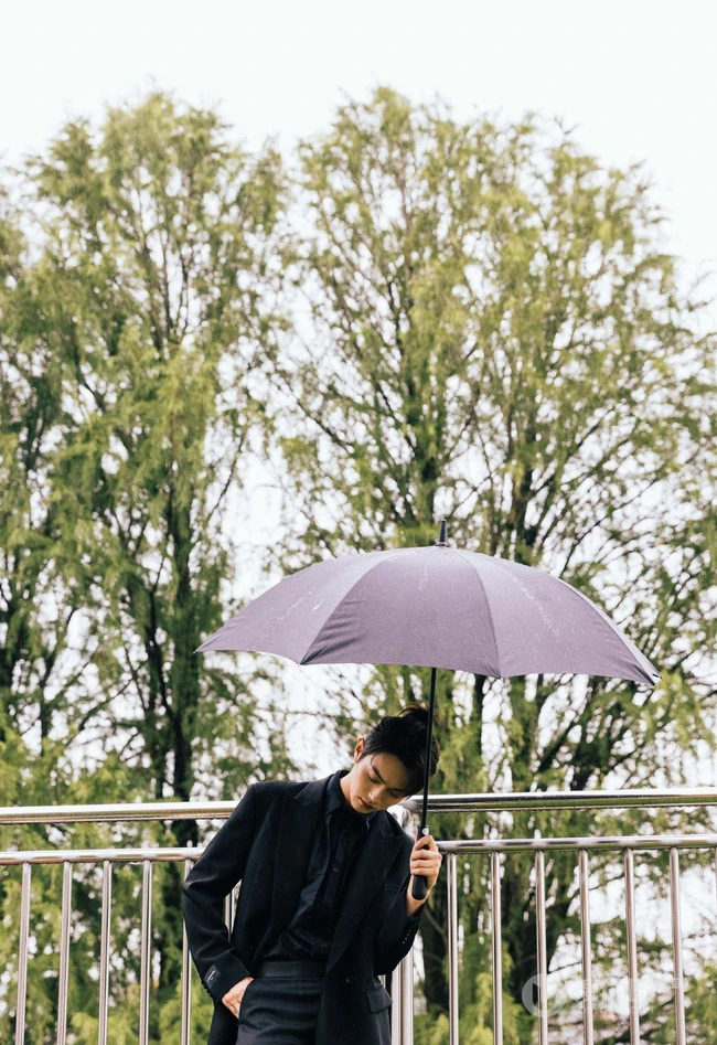 许凯全黑LOOK穿搭下雨天户外帅气十足写真图片
