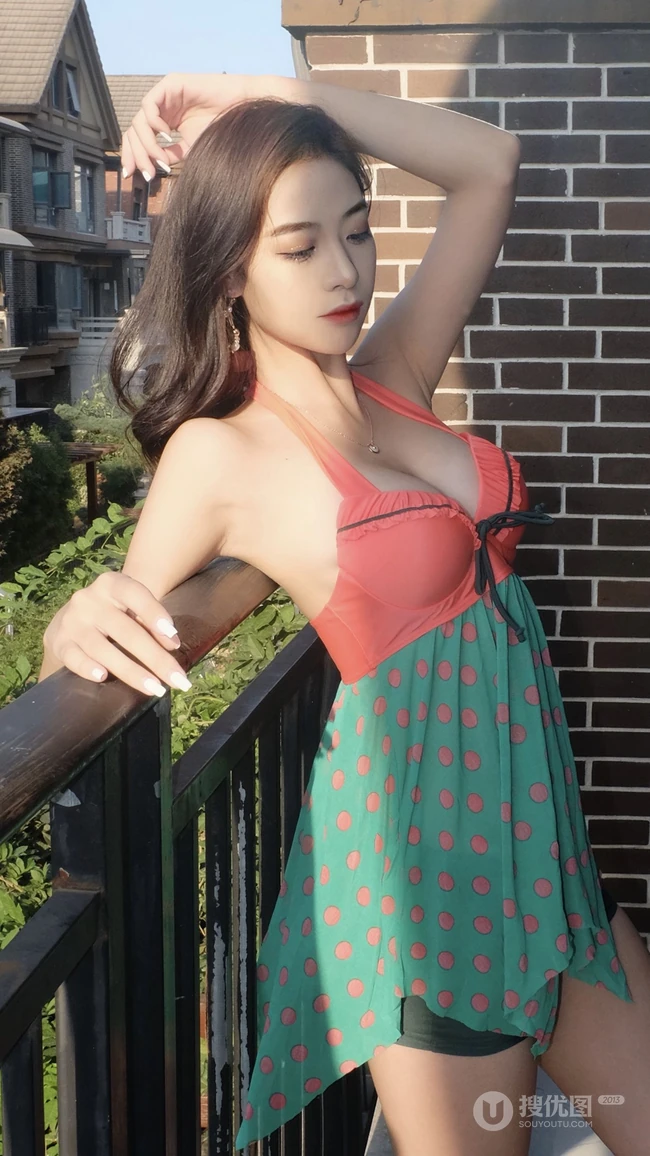 背靠阳台的性感妩媚吊带泳裙美女高清手机壁纸图片