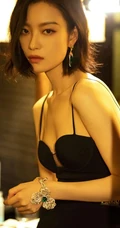 倪妮暖色室内灯光下，身着黑衣肩带裙，一举一动皆自带气质写真图片