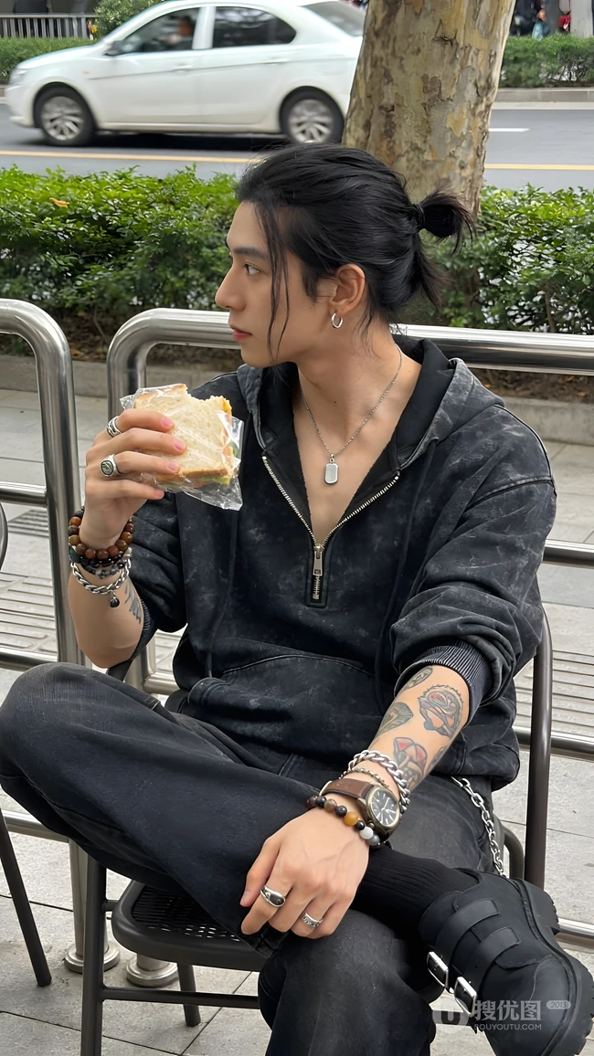 街头扎马尾潮男户外坐着手拿三明治随拍